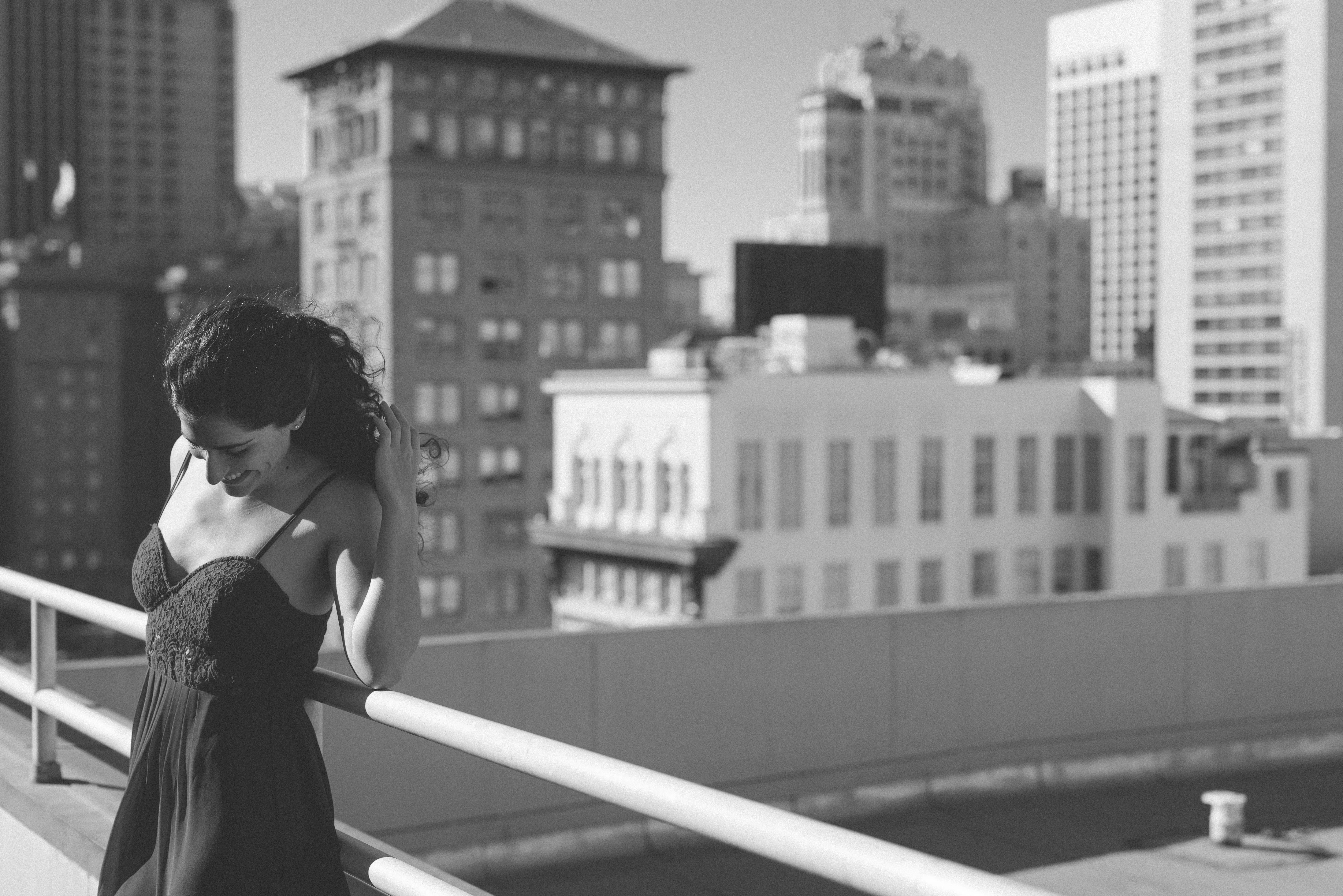 An editorial rooftop portrait of a woman above the city, by Kofi Amoa