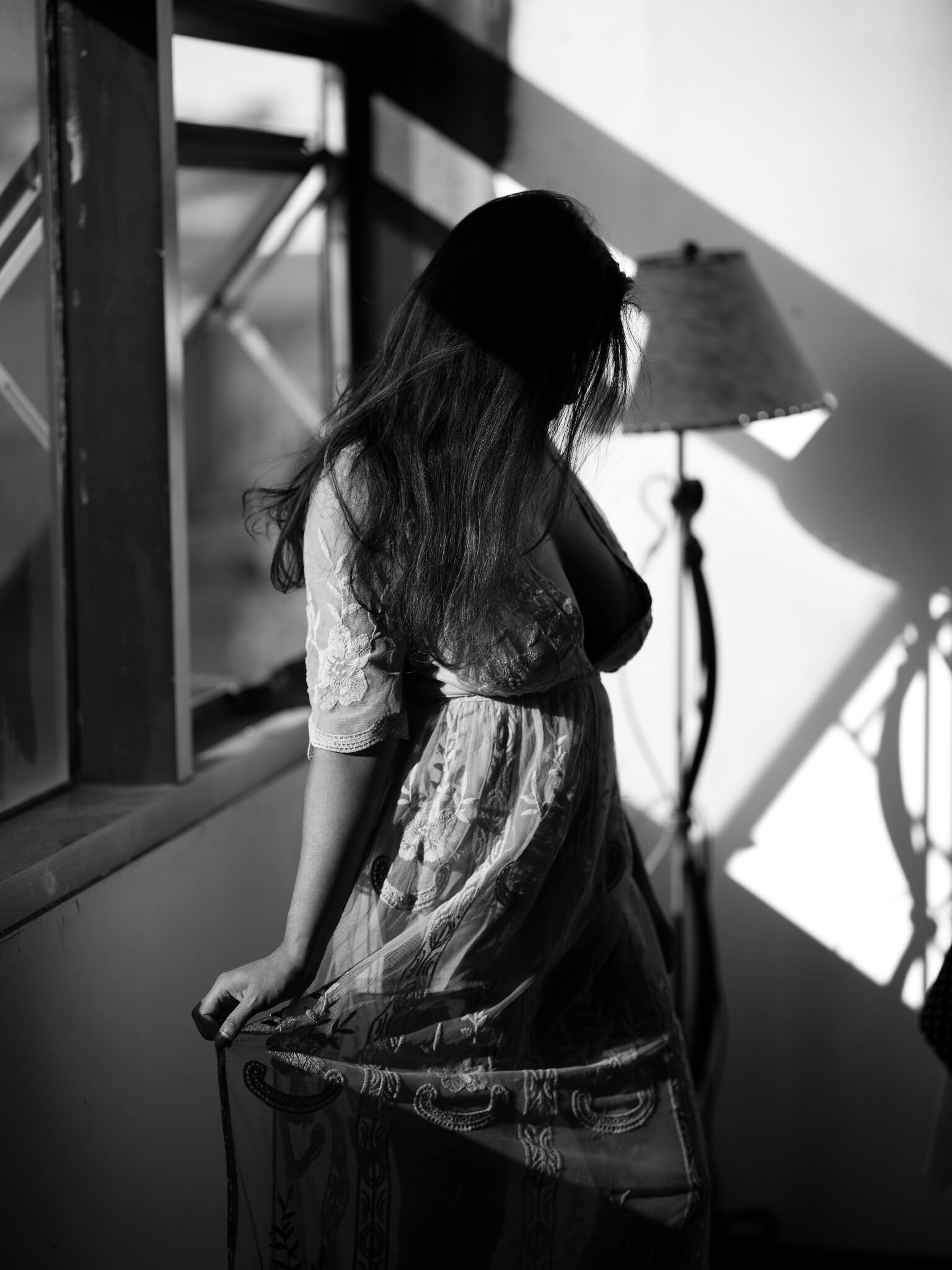 Black and white portrait in window shadow