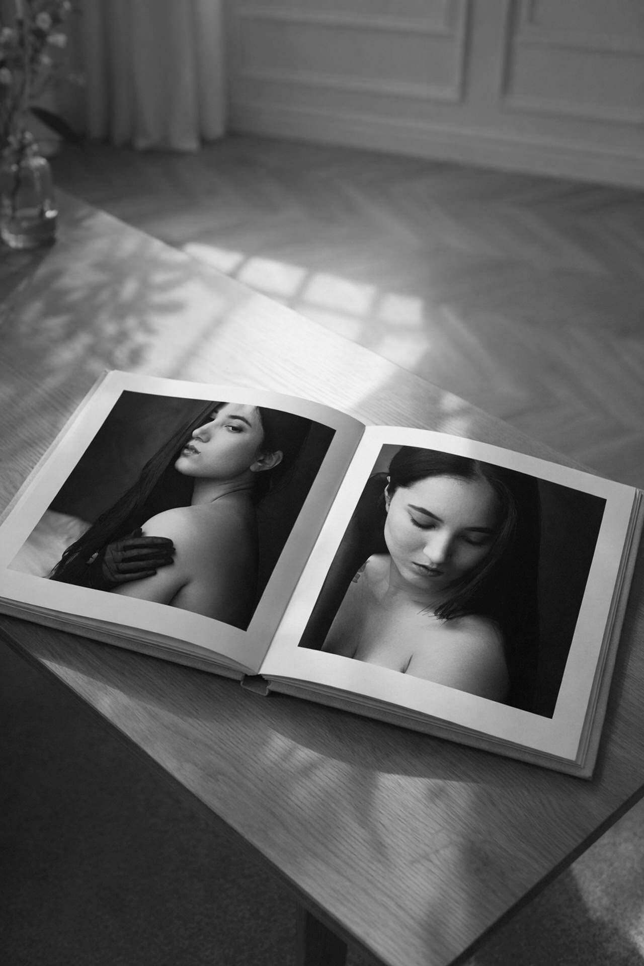 Open portrait album on a table