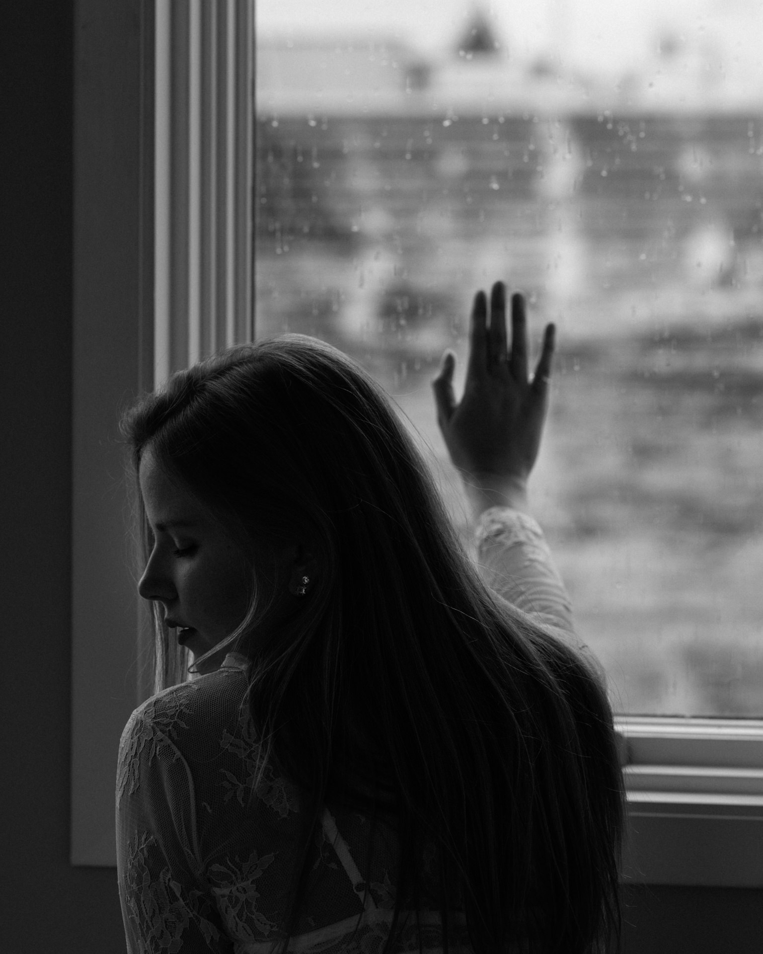 Charlotte at a window on a grey morning
