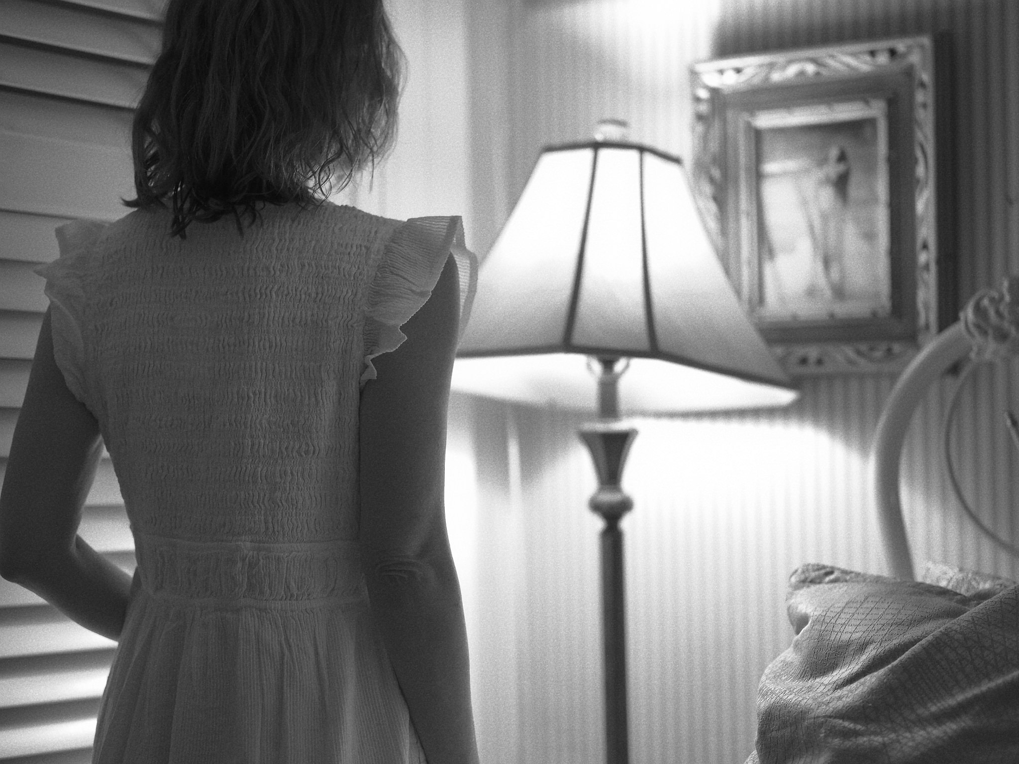 Victoria standing in a softly lit room
