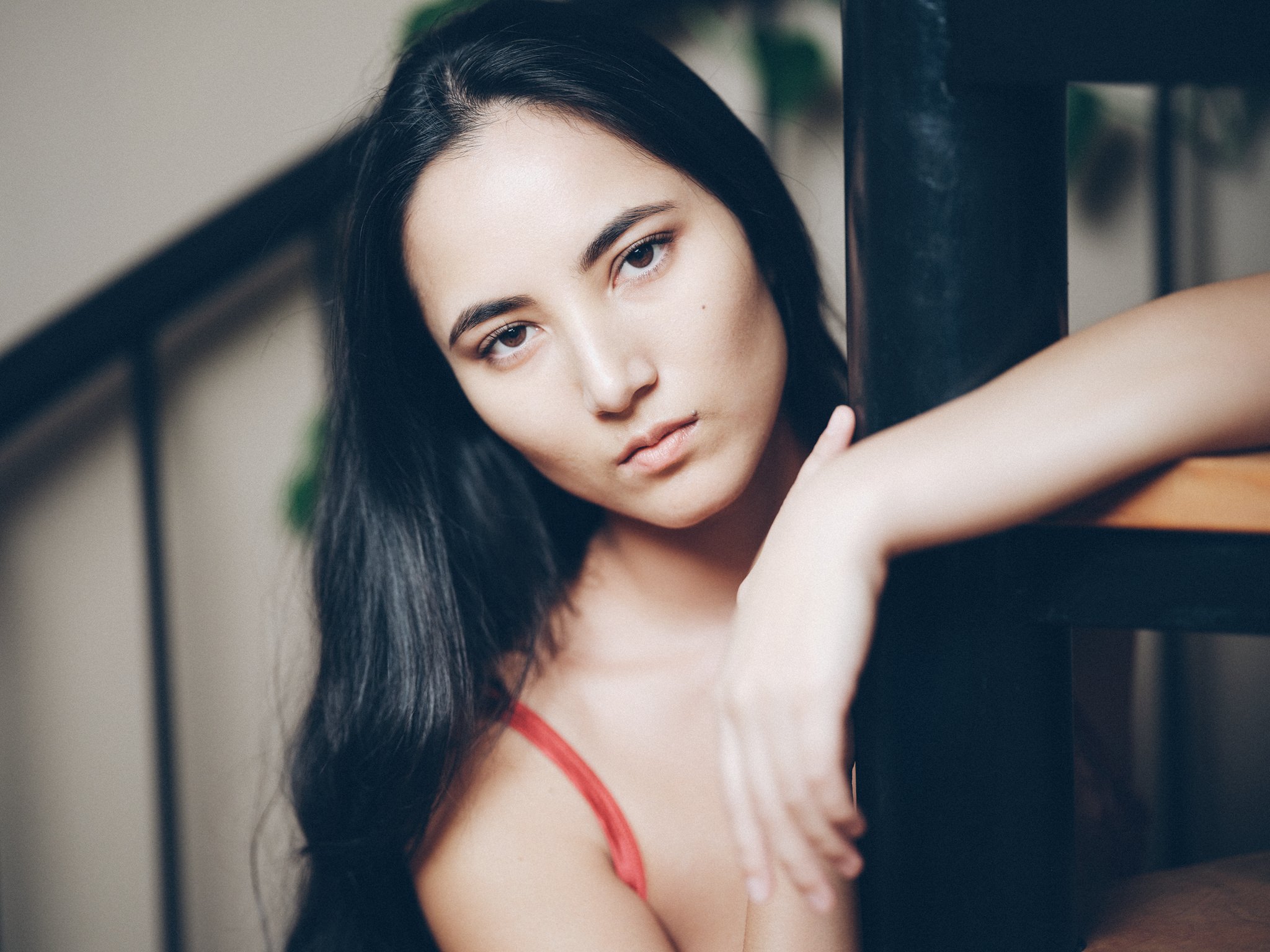 Seraphina reclining in color against a dark interior