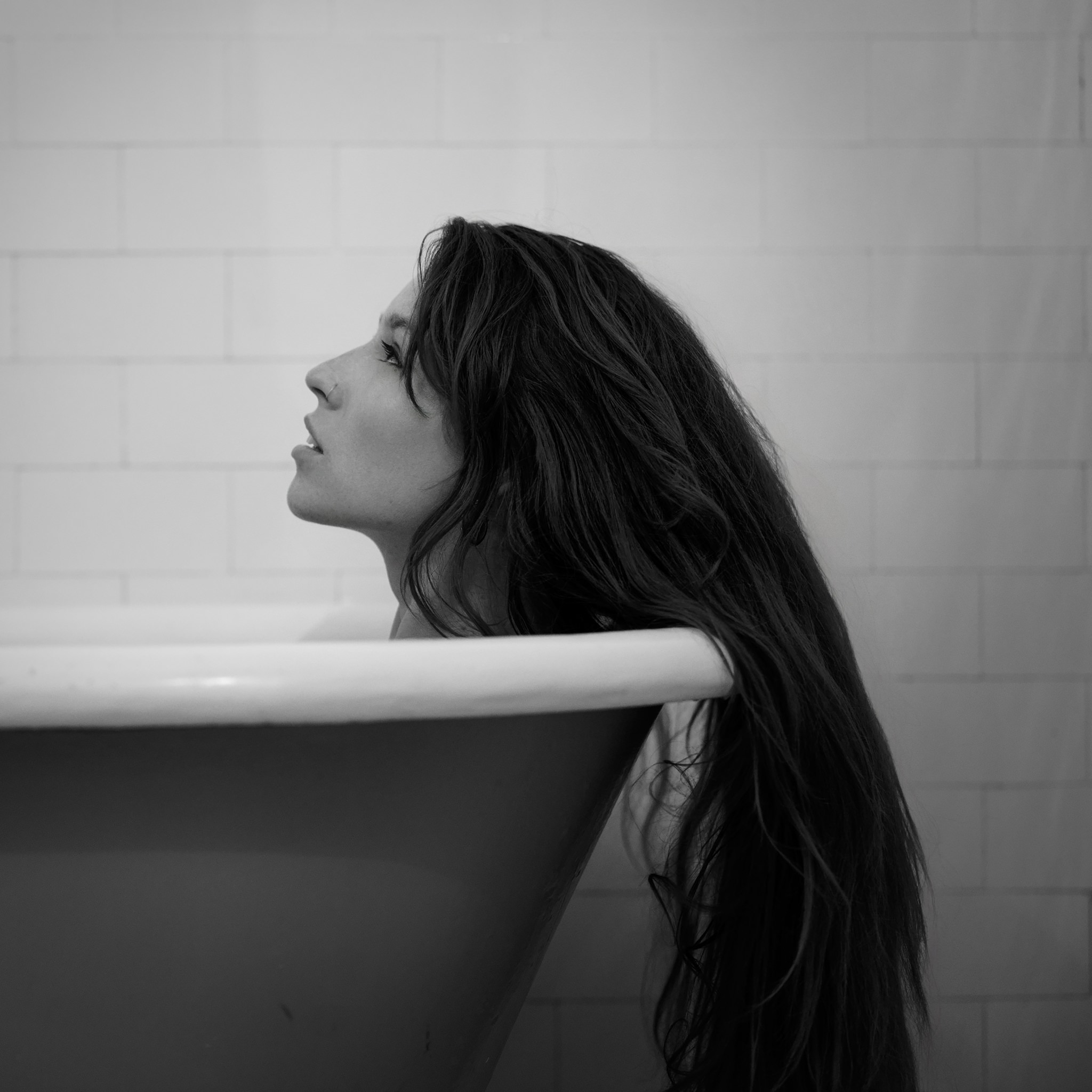Square black and white portrait with direct stillness