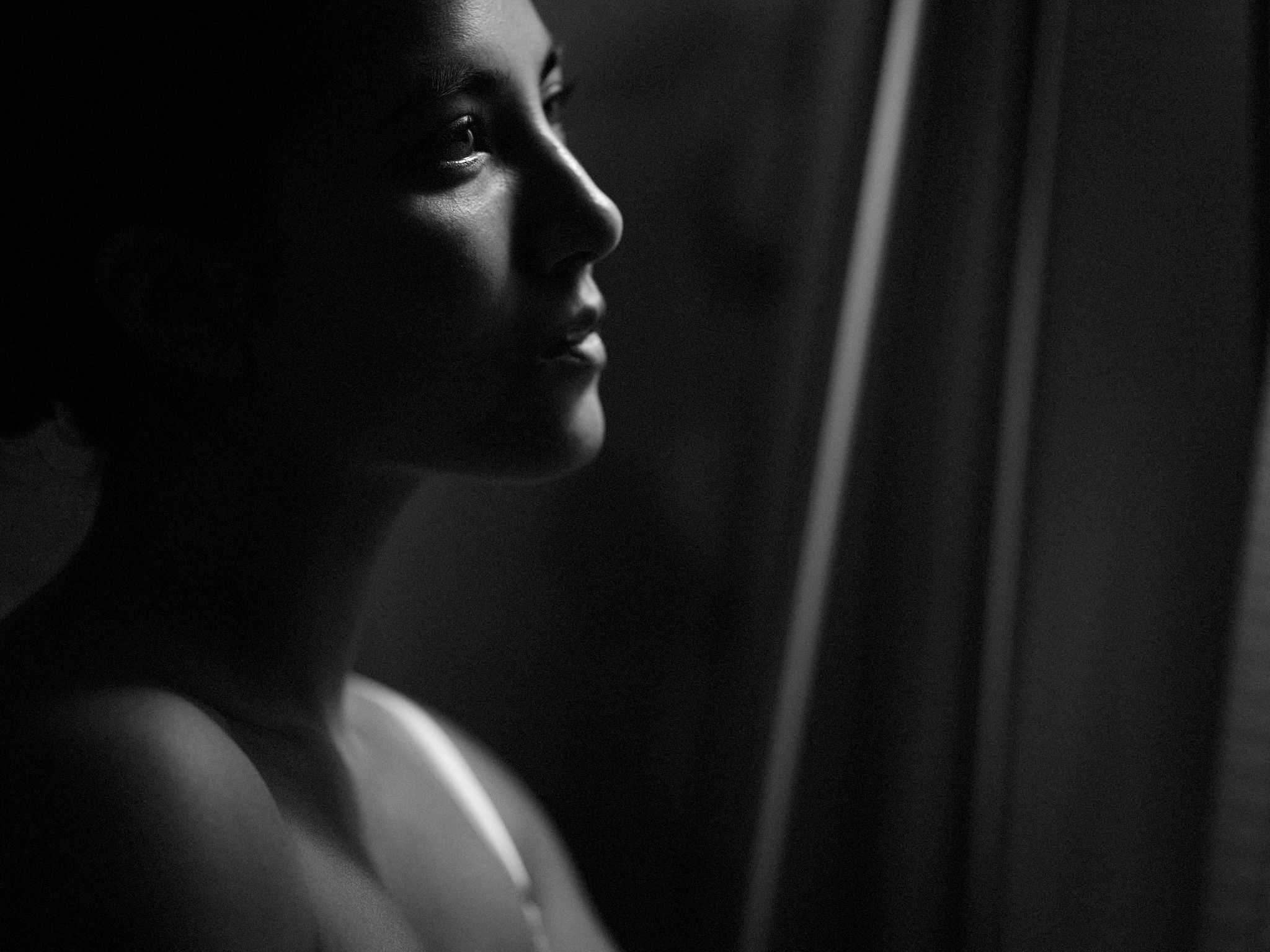 Quiet black and white portrait by window light